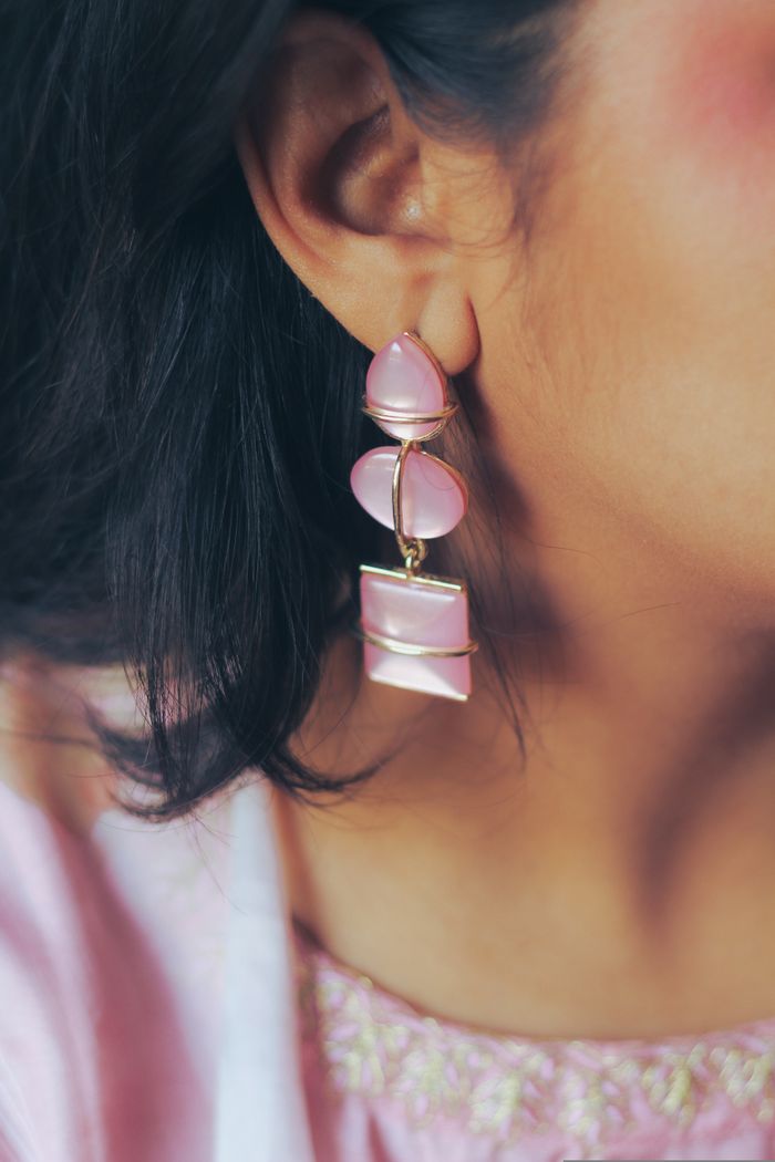 Aesthetic close-up of a woman in Dhaka wearing pink statement earrings showing fashion style.